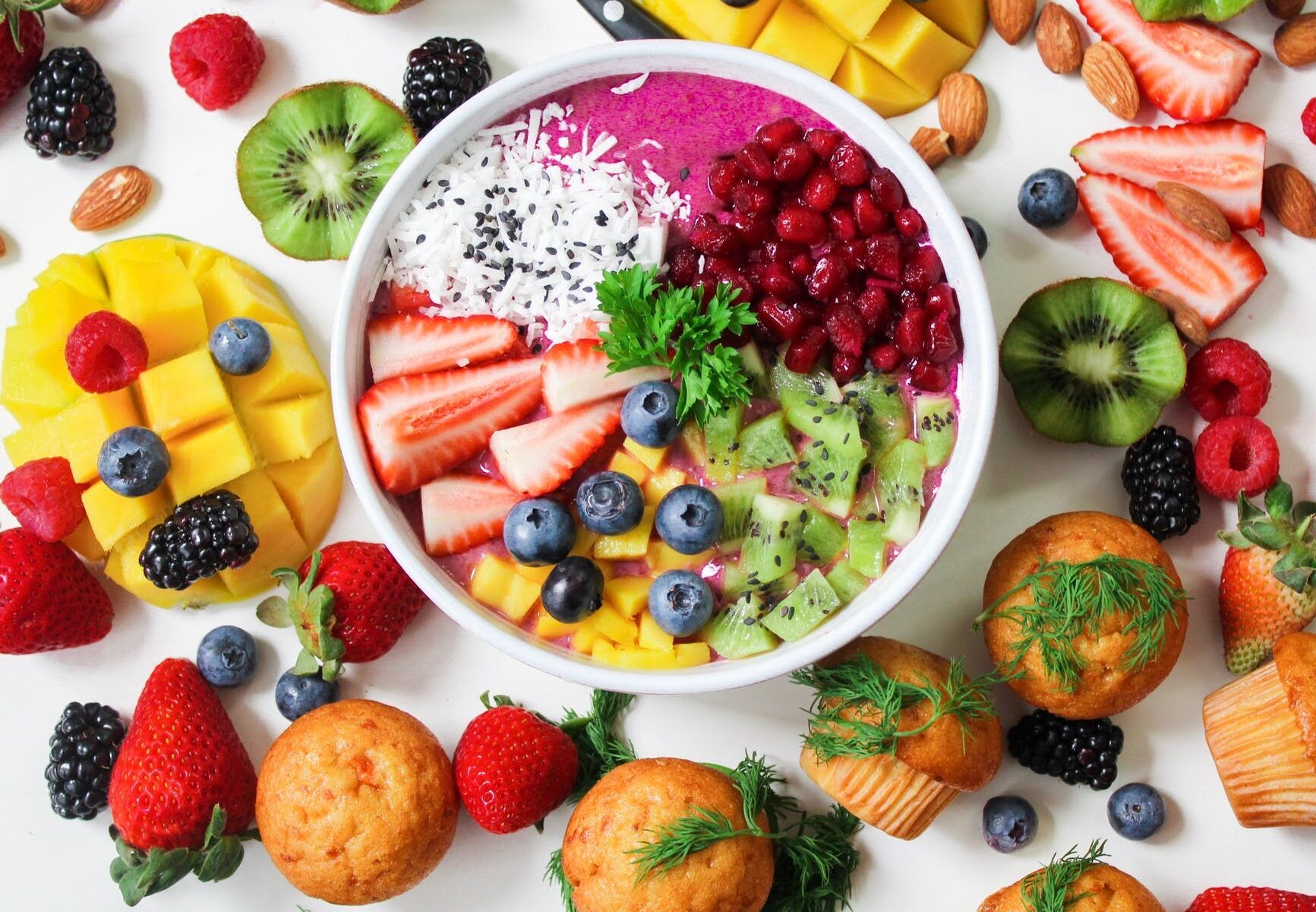 assorted sliced fruits in white ceramic bowl